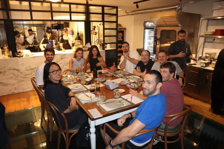 The Matrix One team sharing a long dinner table at the Athens company meetup