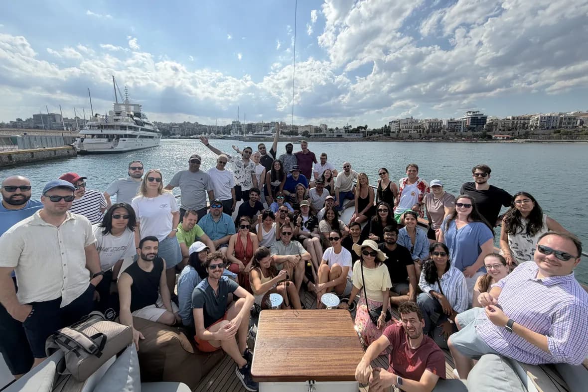 The whole Matrix One team together on a boat deck in the port of Piraeus during the June 2026 company meetup in Athens